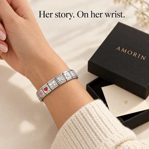 Italian charm bracelet with heart, bow and butterfly charms on a wrist next to an Amorin gift box